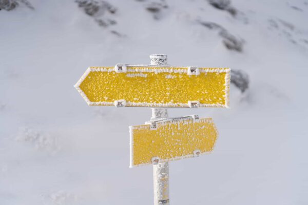 Frozen signs in the snow in the mountains