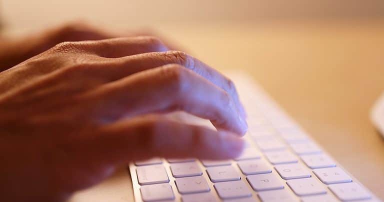 Typing on laptop computer